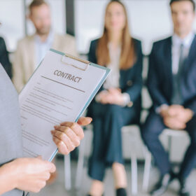 Woman Holding Contract on Clipboard